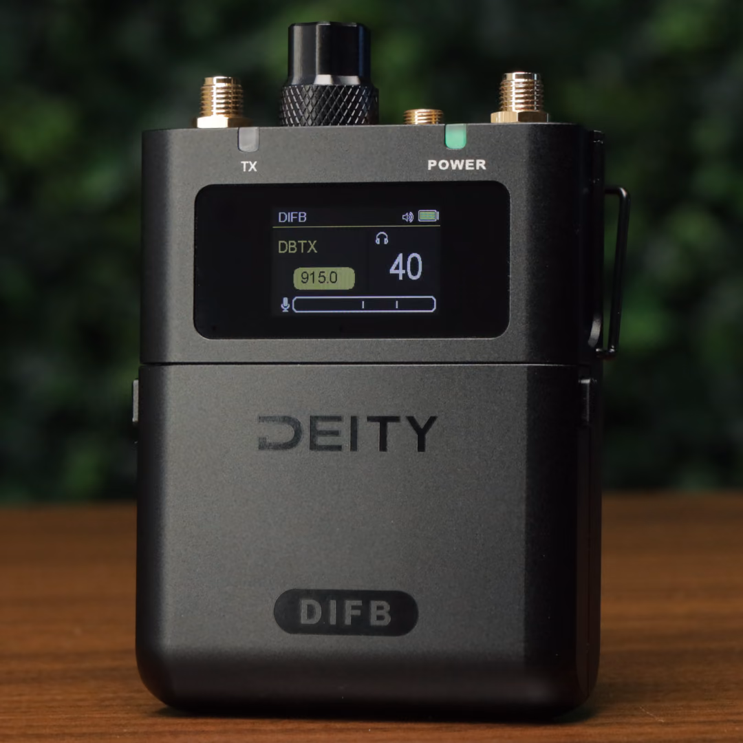 The DIFB standing on a wooden table, knob and gold SMA antenna ports on top, the home screen showing DBTX, 915.0 and volume 40