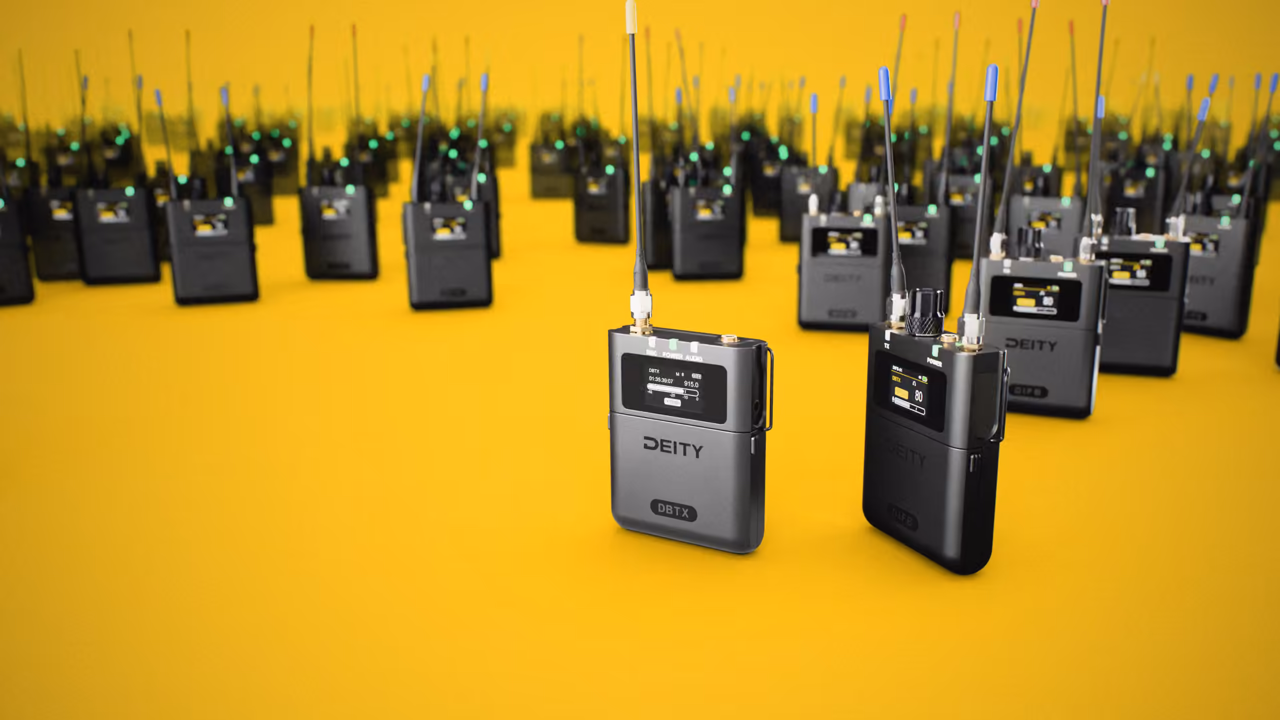 THEOS DIFB receivers around a THEOS DBTX transmitter, screens lit