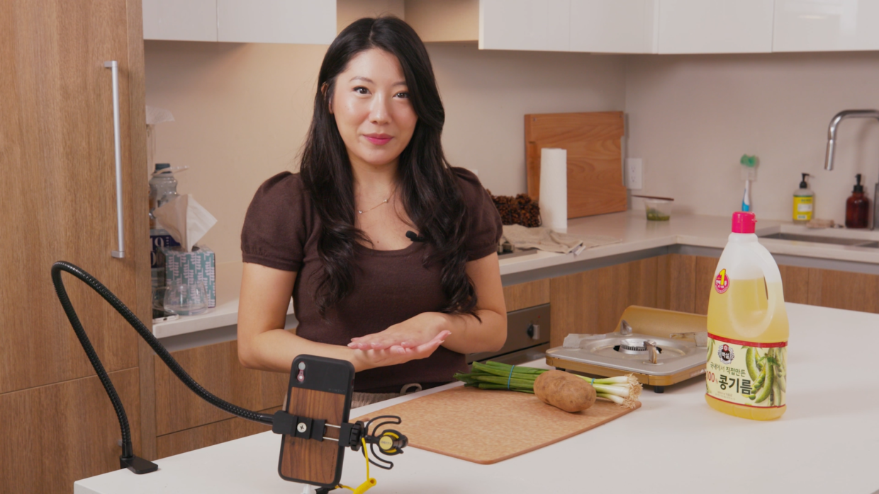 woman filming a cooking video with their iphone and Deity V-Mic D4 mini
