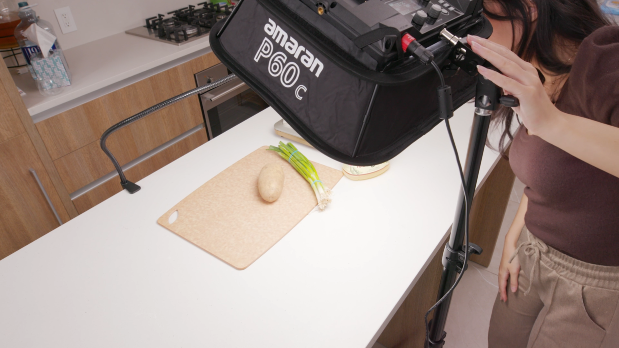 Woman in kitchen setting up amaran P60c