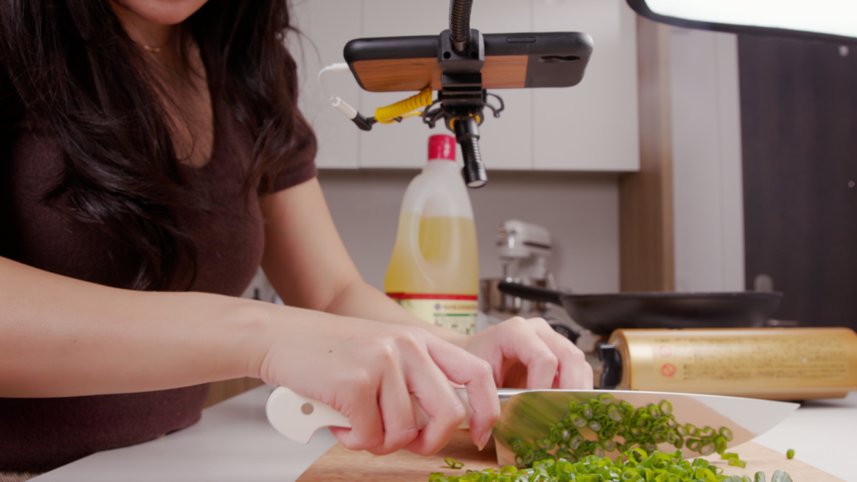 woman filming a cooking video with their iphone and Deity V-Mic D4 mini